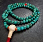 Close-up of genuine natural turquoise mala beads showing unique stone matrix patterns and