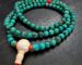 Close-up of genuine natural turquoise mala beads showing unique stone matrix patterns and