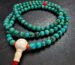 Close-up of genuine natural turquoise mala beads showing unique stone matrix patterns and