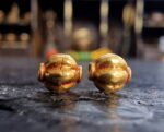 Hand-crafted gold ritual beads with traditional filigree.