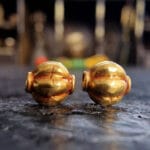 Hand-crafted gold ritual beads with traditional filigree.