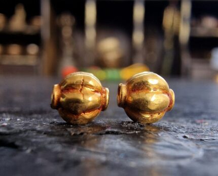 Hand-crafted gold ritual beads with traditional filigree.