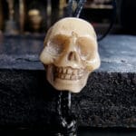 Hand-carved skull ritual bead with a natural aged patina.