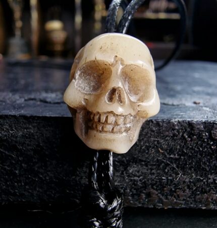 Hand-carved skull ritual bead with a natural aged patina.