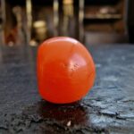 Hand-selected Pema Raka bead with a rich carnelian hue.