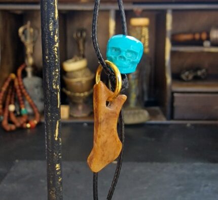 Hand-carved Kapala amulet inlaid with natural turquoise.