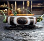 Ancient-style Dzi bead with traditional etched eye patterns.