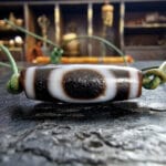 Ancient-style Dzi bead with traditional etched eye patterns.