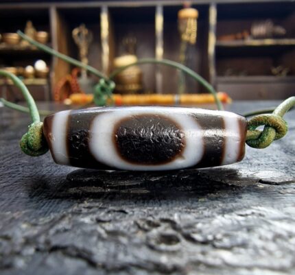 Ancient-style Dzi bead with traditional etched eye patterns.