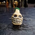 Hand-carved Ivo Chitipati skull amulet with aged patina.