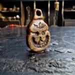 Hand-carved Kapala ritual amulet with traditional skull motifs.