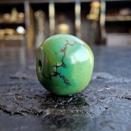 Natural Tibetan turquoise with a rich dark matrix and blue-green hues.