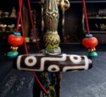 Hand-etched 9 eye Dzi bead with authentic weathered agate.