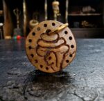 Hand-carved Kapala conch shell with traditional skull motifs.