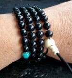 Antique Tibetan turquoise bead with gold spacers detail on wrist