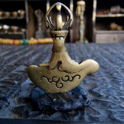 Antique 19th century Kartika thogchag brass amulet close-up