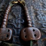 Copper vajra and beads amulet showing age and wear