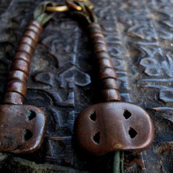 Copper vajra and beads amulet showing age and wear