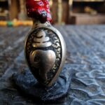 Tibetan silver mala conch shell amulet close-up