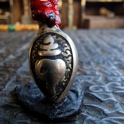 Tibetan silver mala conch shell amulet close-up