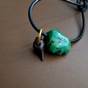 Tibetan turquoise and thogchag amulet close-up