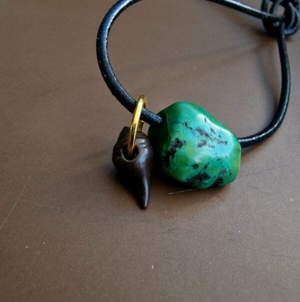 Tibetan turquoise and thogchag amulet close-up