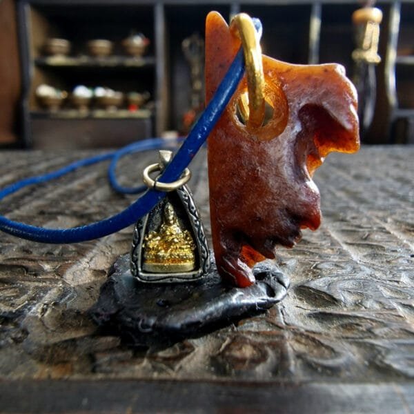Tibetan kapala amulet with Buddha ghau charm