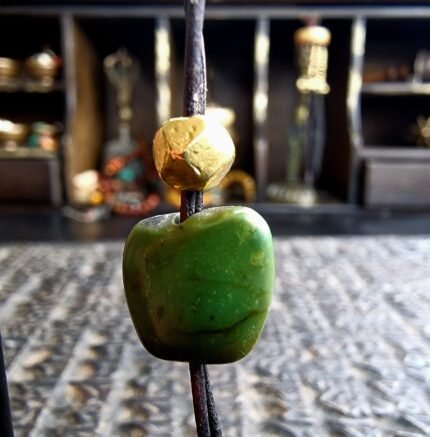 Tibetan turquoise bead with gold wax and patina detail