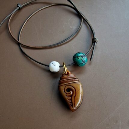 Tibetan kapala amulet with turquoise bead