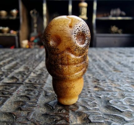 Hand-carved antique bone Kapala guru bead with a rich ritual patina.