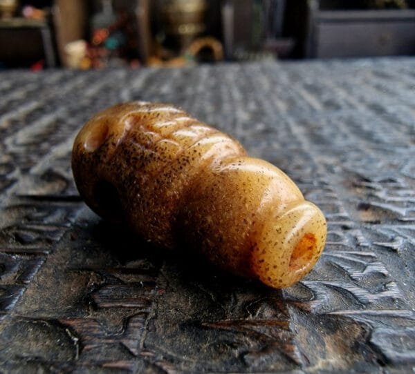 Antique kapala guru bead close-up with patina