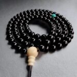 Black onyx mala necklace full view on grey