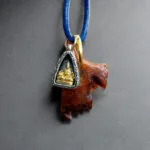 Tibetan kapala and Buddha ghau amulet close-up