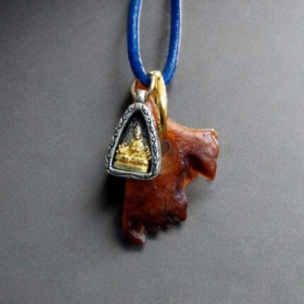 Tibetan kapala and Buddha ghau amulet close-up