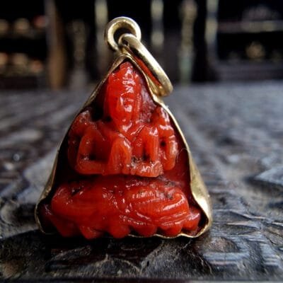 Tibetan red coral bead intaglio in gold frame