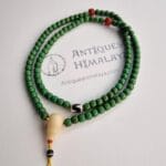 Hand-strung 108 turquoise prayer beads featuring a central etched Dzi bead and resin Guru.