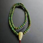 Antique Tibetan turquoise prayer beads featuring a rich, weathered blue-green matrix.