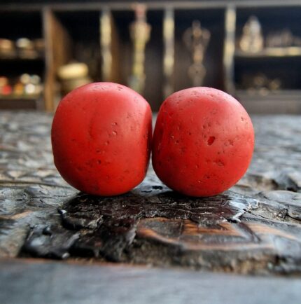 Authentic Sherpa coral beads featuring a rich red hue and natural weathered texture.