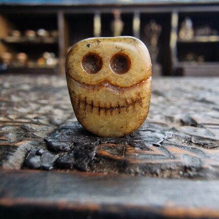 Hand-carved bone Kapala Chitipati bead featuring a detailed wrathful skull.