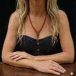 Hand-strung red coral mala necklace featuring 108 beads and a central bone Citipati skull.