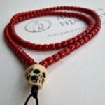 Hand-polished 108 red coral mala beads with an ivory bone skull guru.
