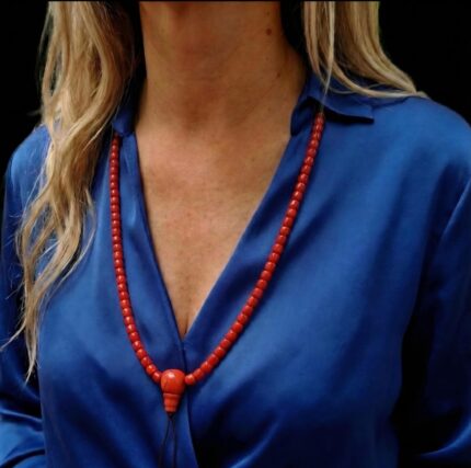 Hand-strung red coral mala necklace featuring 108 vibrant Mediterranean coral beads for ritual use.