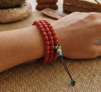 Hand-polished Sherpa coral mala beads with authentic ritual wear.