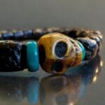 Hand-strung Rudraksha beads bracelet with a central hand-carved bone Kapala skull.