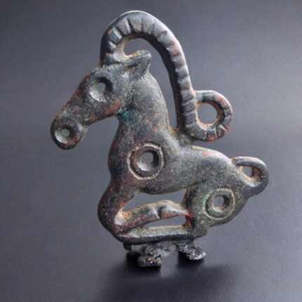 Hand-forged Tibetan Wind Horse Thogchag amulet with a dark metallic patina and ritual wear.