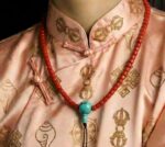 Hand-polished 6mm red coral prayer beads with a natural turquoise guru bead.