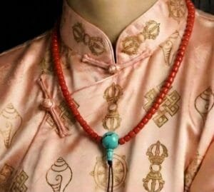 Hand-polished 6mm red coral prayer beads with a natural turquoise guru bead.