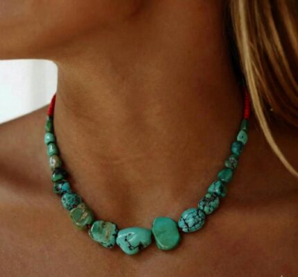 "Female model wearing a handcrafted Ancient Tibetan Turquoise Necklace featuring high-value antique beads with a deep natural patina."