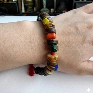 Hand-carved antique Tibetan kapala bone bracelet on the wrist