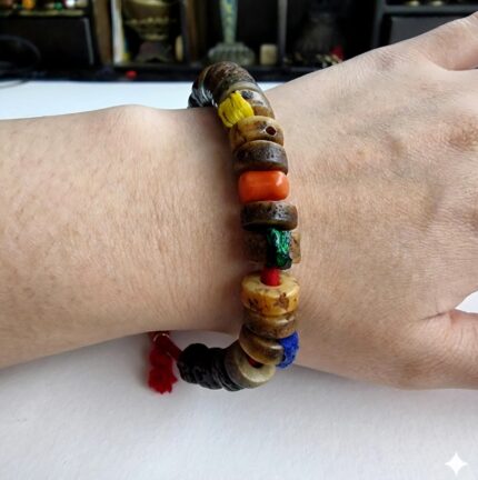 Hand-carved antique Tibetan kapala bone bracelet on the wrist